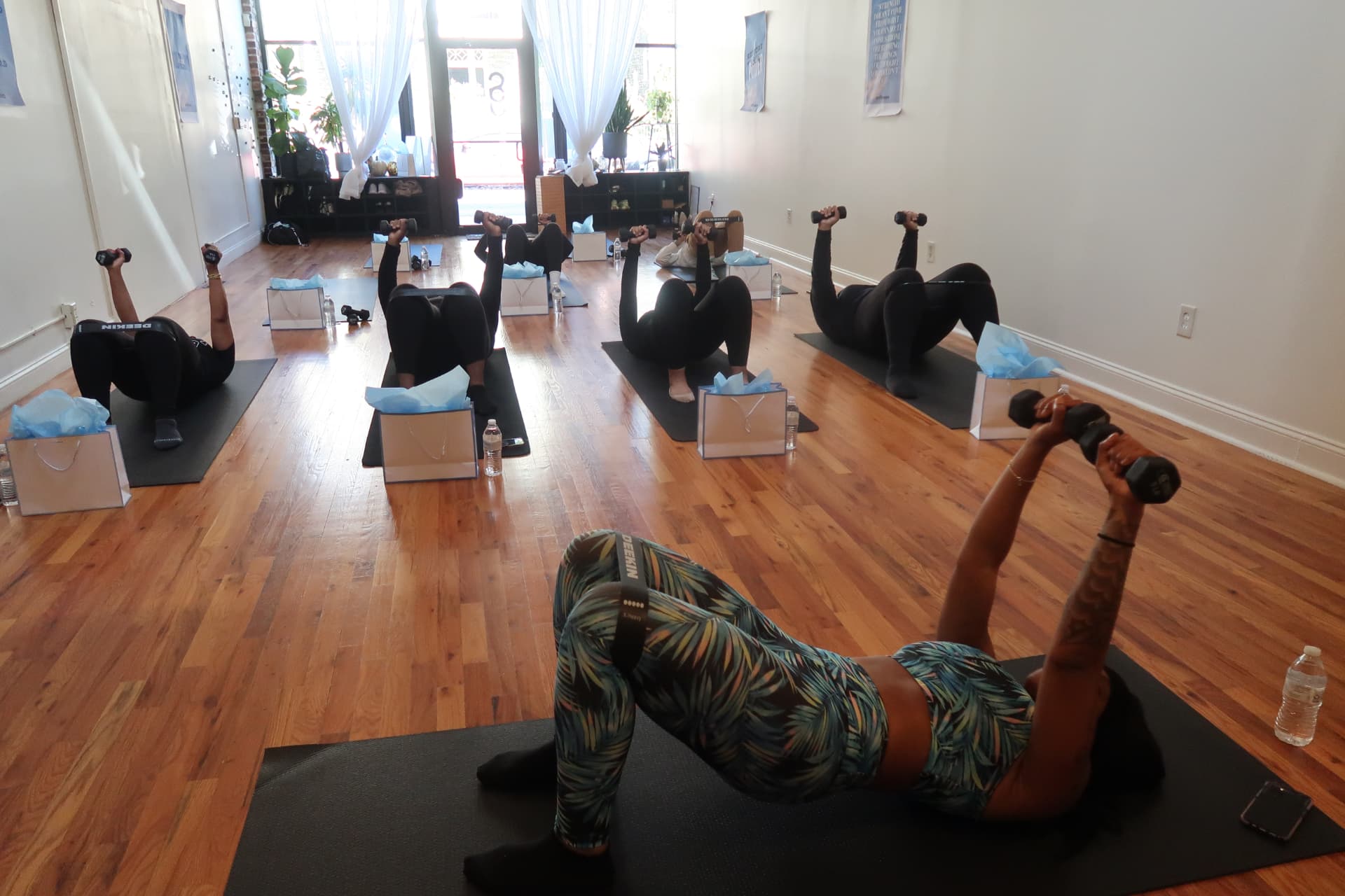 Women participating in a guided strength workout at Revitalize 2024