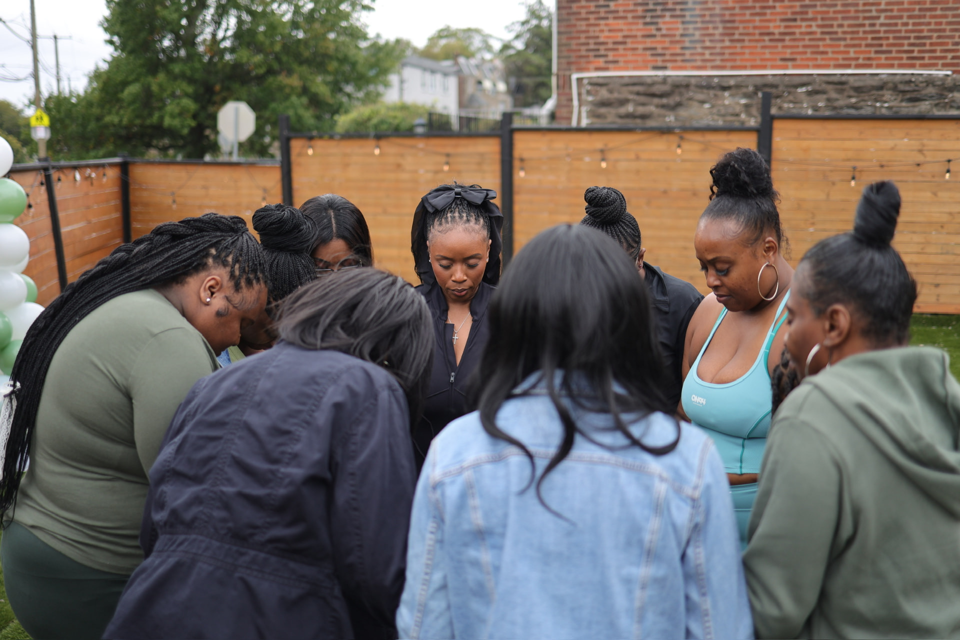 Women gathered in prayer at Restore, Strengthen & Live Whole 2025
