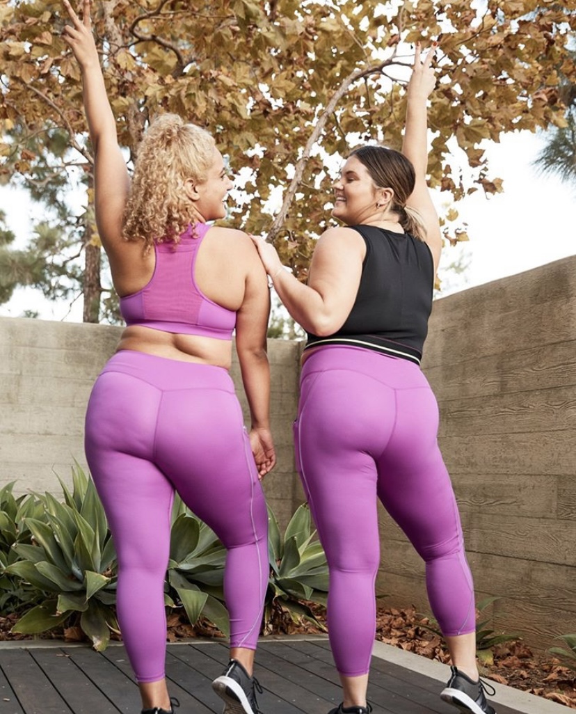 Two women celebrating movement together outdoors