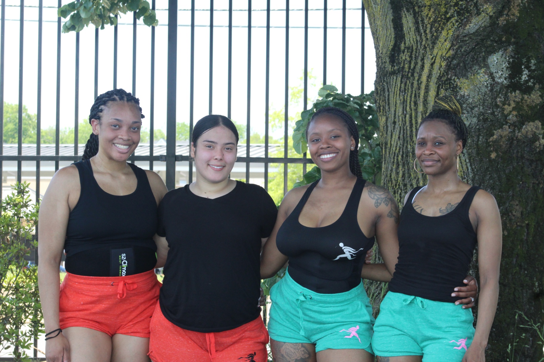 Four women standing together in the AyrFitWomen community